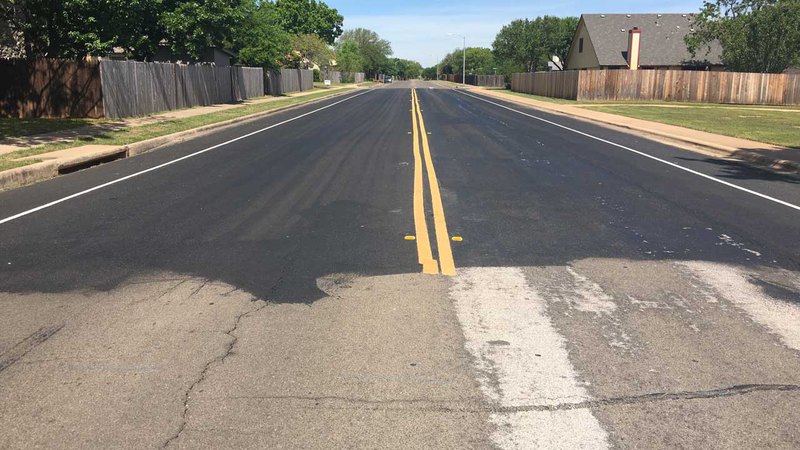 before and after asphalt driveway maintenance; observe the improved look of the road free of cracks